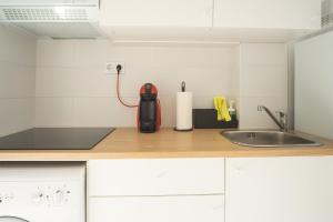 a kitchen counter with a sink and a mixer at Casa Carmelina in Torrevieja