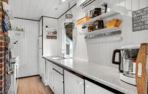 a kitchen with white cabinets and a counter top at 2 Bedroom Lovely Home In Hemmet in Hemmet +9 photos