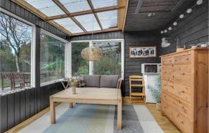 a living room with a couch and a table at 2 Bedroom Lovely Home In Hemmet in Hemmet