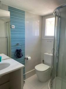 a bathroom with a toilet and a sink and a shower at Villa Bounatsa with access to semi-private beach in Kanapitsa