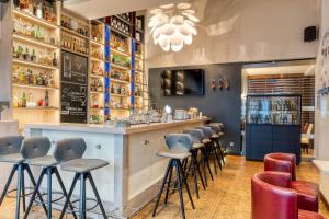 a bar in a restaurant with stools at Inselhotel König in Norderney