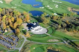 an aerial view of a large house on a golf course at New lakehouse - amazing sea view and private pier! in Stockholm