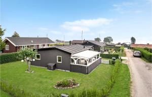 a black house on a yard with a driveway at Pet Friendly Home In Hejls With Wifi in Hejls