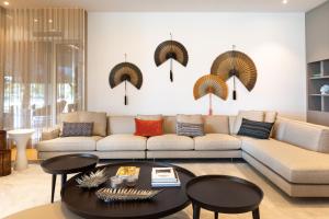 a living room with a couch and a table at Hiddenbay Teos Hotel in Seferihisar +270 photos