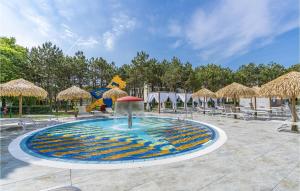 a fountain in a courtyard with chairs and umbrellas at Summertime in Bibione +18 photos
