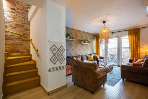 ein Wohnzimmer mit einem Sofa und einer Treppe in der Unterkunft Bohome Budapest in Budapest