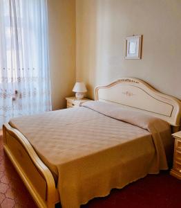 a bedroom with a large bed and a window at Villa fronte mare in Levanto