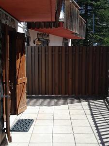 a wooden fence in front of a house at Casa MARIA in Limone Piemonte