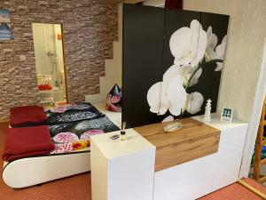 een slaapkamer met een bed met een bloemenfoto aan de muur bij Ferienwohung Marina in Großwoltersdorf +22 foto's