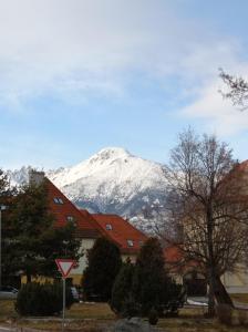 a snow covered mountain in front of a house at Dom pod Tatrami. in Veľký Slavkov