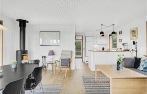 a living room and a kitchen with a stove at Beautiful Home In Faaborg With Kitchen in Fåborg