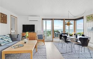 a living room with a couch and a table at Beautiful Home In Faaborg With Kitchen in Fåborg