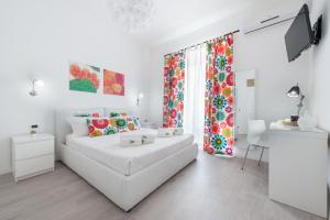 a white living room with a white couch and a window at Room & Breakfast Zero in Palermo