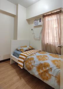 Ένα ή περισσότερα κρεβάτια σε δωμάτιο στο Infina Towers affordable staycation and spacious 2BR condo Quezon City