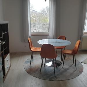 uma mesa e cadeiras num quarto com uma janela em Das Düsselapartment em Haan