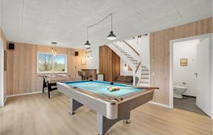 a pool table in a room with a staircase at Beautiful Home In Spttrup With Wifi in Lihme