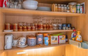 a pantry with jars and other items on shelves at Lovely Apartment In Schleswig With Wifi in Schleswig