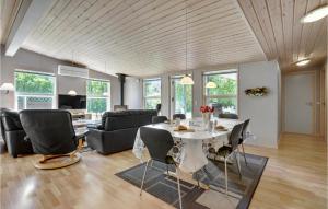 a living room with a table and chairs at Pet Friendly Home In Væggerløse in Marielyst