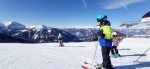 a group of people standing on a ski slope at Haus Elli in Greifenburg