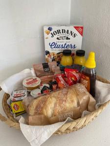 a basket with a loaf of bread and other food at Travellers Retreat Bayview in Bay View