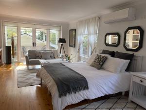 a bedroom with a large bed and a couch at Travellers Retreat Bayview in Bay View