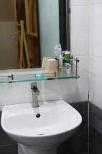 a bathroom with a white sink and a mirror at Big Măng Đen Homestay in Kon Von Kla