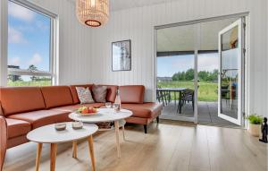a living room with a couch and a table at Stunning Home In Lgstrup With Wifi in Løgstrup