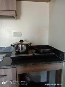 a pot sitting on top of a stove in a kitchen at Unit Near SM City,Gaisano Mall of Cebu,Robinsons Galleria in Cebu City