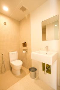 a bathroom with a toilet and a sink at Lantern Hotel in Kuala Lumpur