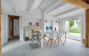 a white dining room with a white table and chairs at Stunning Home In Skibby With Kitchen in Skibby