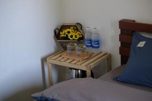 a table with water bottles and glasses on it next to a bed at Big Măng Đen Homestay in Kon Von Kla