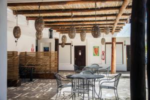 a room with tables and chairs and wooden ceilings at Hotel Maioris La Paz in La Paz