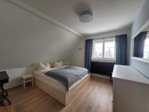 a bedroom with a bed and a desk in it at Hillehof Ostrau in Bad Schandau