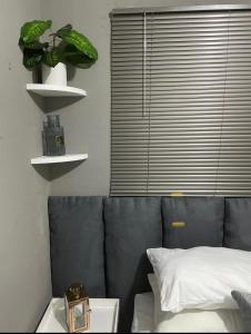 a bedroom with a bed and a plant on a shelf at Solace Unit in Phalaborwa