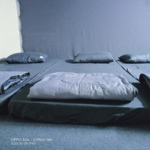 two beds with pillows on the floor in a room at Big Măng Đen Homestay in Kon Von Kla