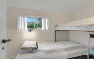 a white bedroom with a bunk bed and a window at Cozy Home In Nex With Wifi in Neksø