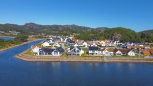 an aerial view of a town next to the water at Apartment with boat in Spangereid