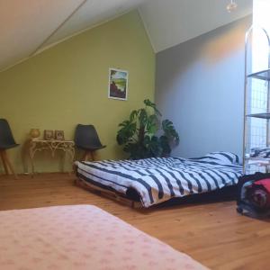 a bedroom with a bed and a plant in it at Atelier Aan Zee in Ostend