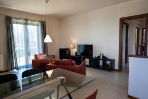 a living room with a couch and a tv at Casa Terra d'Aci in Aci Bonaccorsi