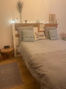 a bedroom with a large bed with two pillows at Au Coeur de Cassis in Cassis