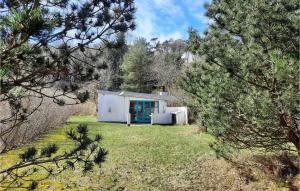 a small white building in the middle of a forest at 3 Bedroom Lovely Home In Anholt in Anholt
