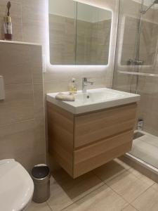 a bathroom with a sink and a toilet and a mirror at Au Coeur de Cassis in Cassis +15 photos