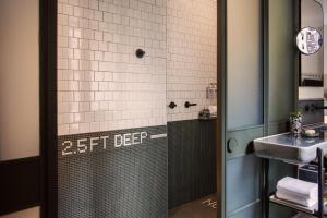 a bathroom with a shower and a sink at MOXY NYC Times Square in New York
