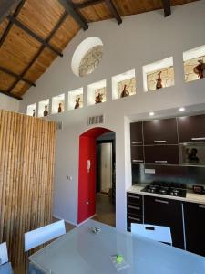 a kitchen with a white table and a red door at Le Torri in Cagliari