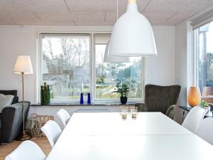 ein weißes Esszimmer mit einem weißen Tisch und Stühlen in der Unterkunft Holiday home Ebeltoft CXCVI in Ebeltoft