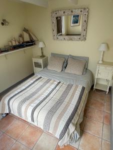 エターブルにあるMaisonnette à Etables ; La Bleueのベッドルーム1室(ストライプ毛布付きのベッド1台付)