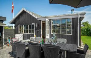 a small black shed with a table and chairs at Awesome Home In Nyborg With Wifi in Nyborg