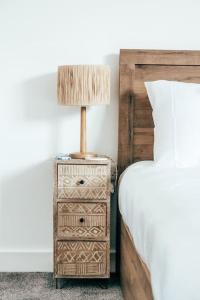 a night stand with a lamp next to a bed at The Hideout - Newquay - Fully Stocked Eco Escape in Newquay