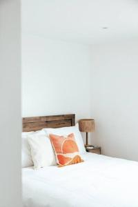 a bed with white sheets and pillows on it at The Hideout - Newquay - Fully Stocked Eco Escape in Newquay