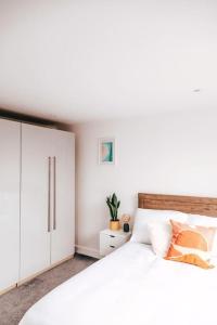 a bedroom with a white bed and a white cabinet at The Hideout - Newquay - Fully Stocked Eco Escape in Newquay